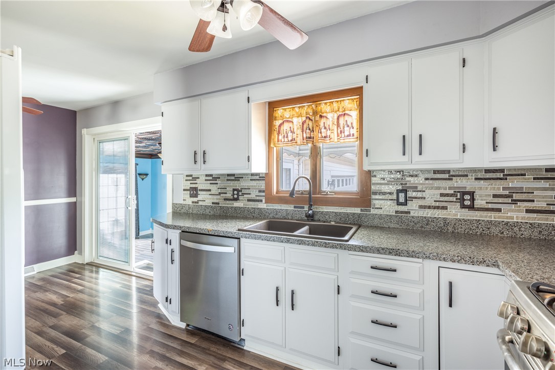 29220 Ridge Road Wickliffe, OH 44092 - Photo 16 of 34 Kitchen with white cabinetry, dark wood-type flooring, appliances with stainless steel finishes, sink, and ceiling fan