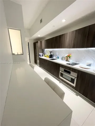 a kitchen with stainless steel appliances a sink dishwasher stove and cabinets