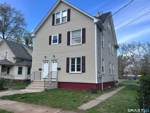 a front view of a house with a yard