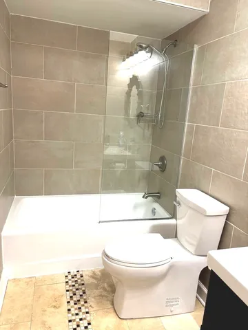 a bathroom with a toilet and a shower