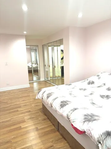 a view of a bedroom with wooden floor and bedroom