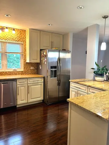 a kitchen with stainless steel appliances a refrigerator and a stove