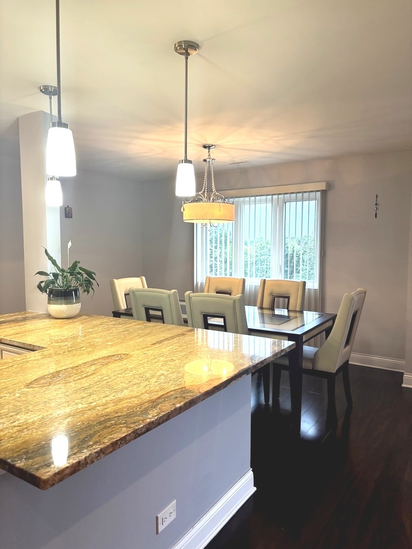9332 Landings Lane, Unit 504 Des Plaines, IL 60016 - Photo 8 of 18 a view of a dining room with furniture window and wooden floor