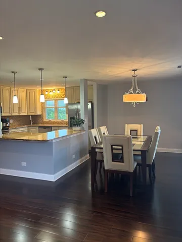 a view of a dining room with furniture wooden floor and chandelier