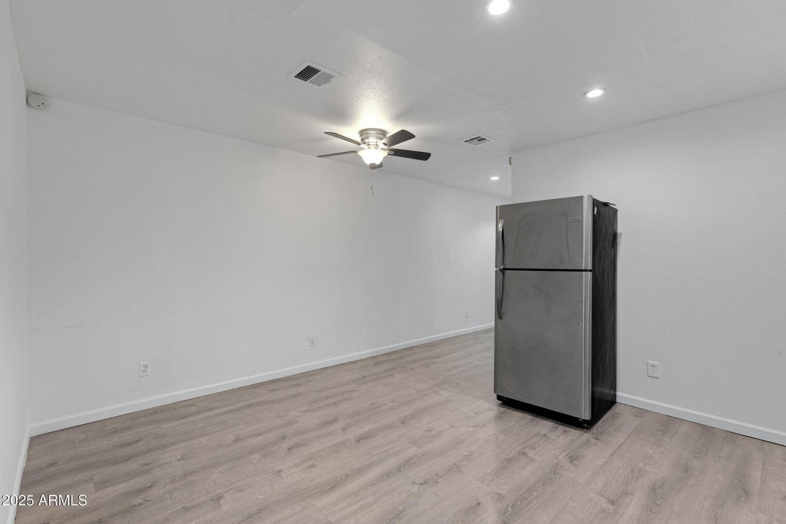 18202 North Cave Creek Road Phoenix, AZ 85032 - Photo 3 of 20 wooden floor in an empty room with a window