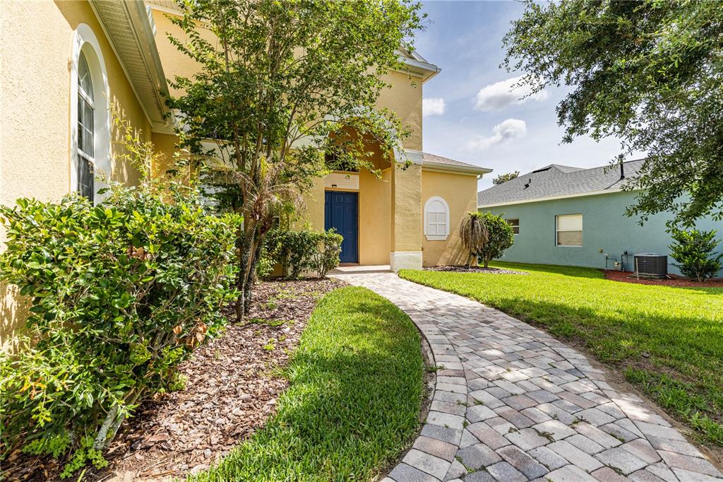 2718 Knightsbridge Road Clermont, FL 34711 - Photo 57 of 72 a front view of a house with garden