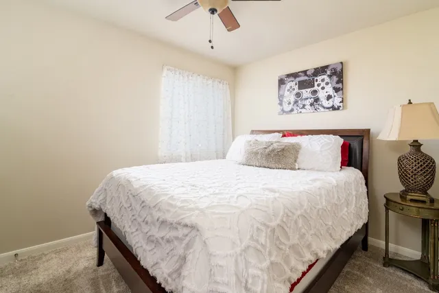 a large bed sitting in a bedroom next to a window