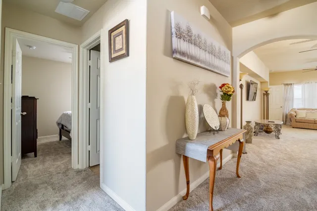 a view of a hallway with couch and closet