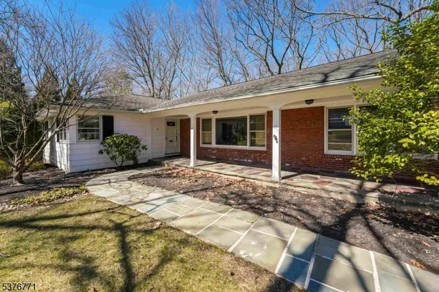a view of a house with a yard and plants
