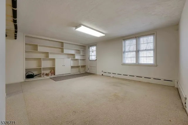 a view of a house with a yard covered with snow