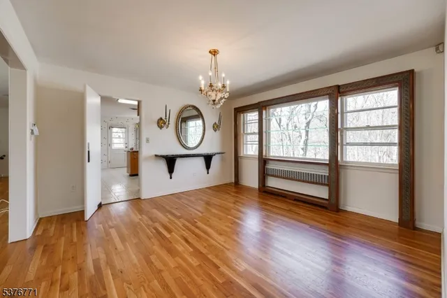 a view of a room with wooden floor and window