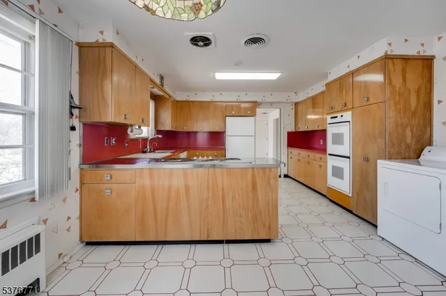 a kitchen with stainless steel appliances granite countertop a refrigerator and a stove