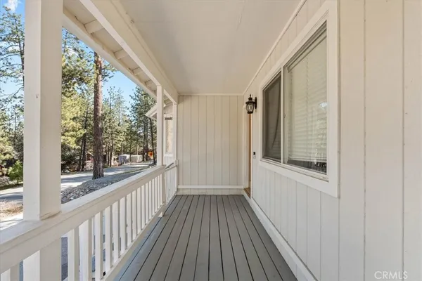 a view of a room with wooden floor and windows
