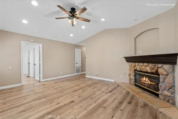 a view of an empty room with a fireplace