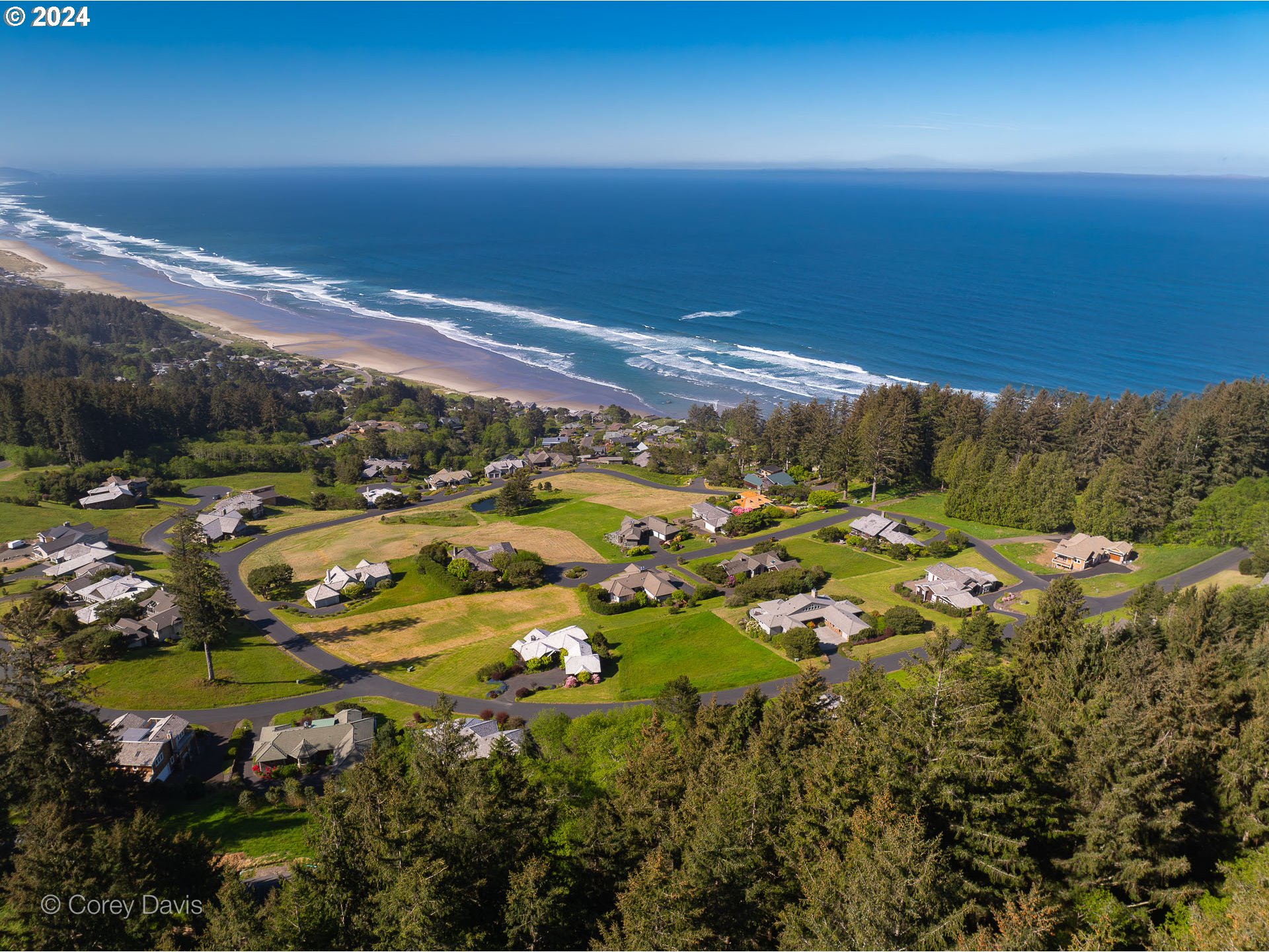 Meadow Loop, Unit 14 Nehalem, OR 97131 - Photo 11 of 22 an aerial view of residential houses with outdoor space and trees all around
