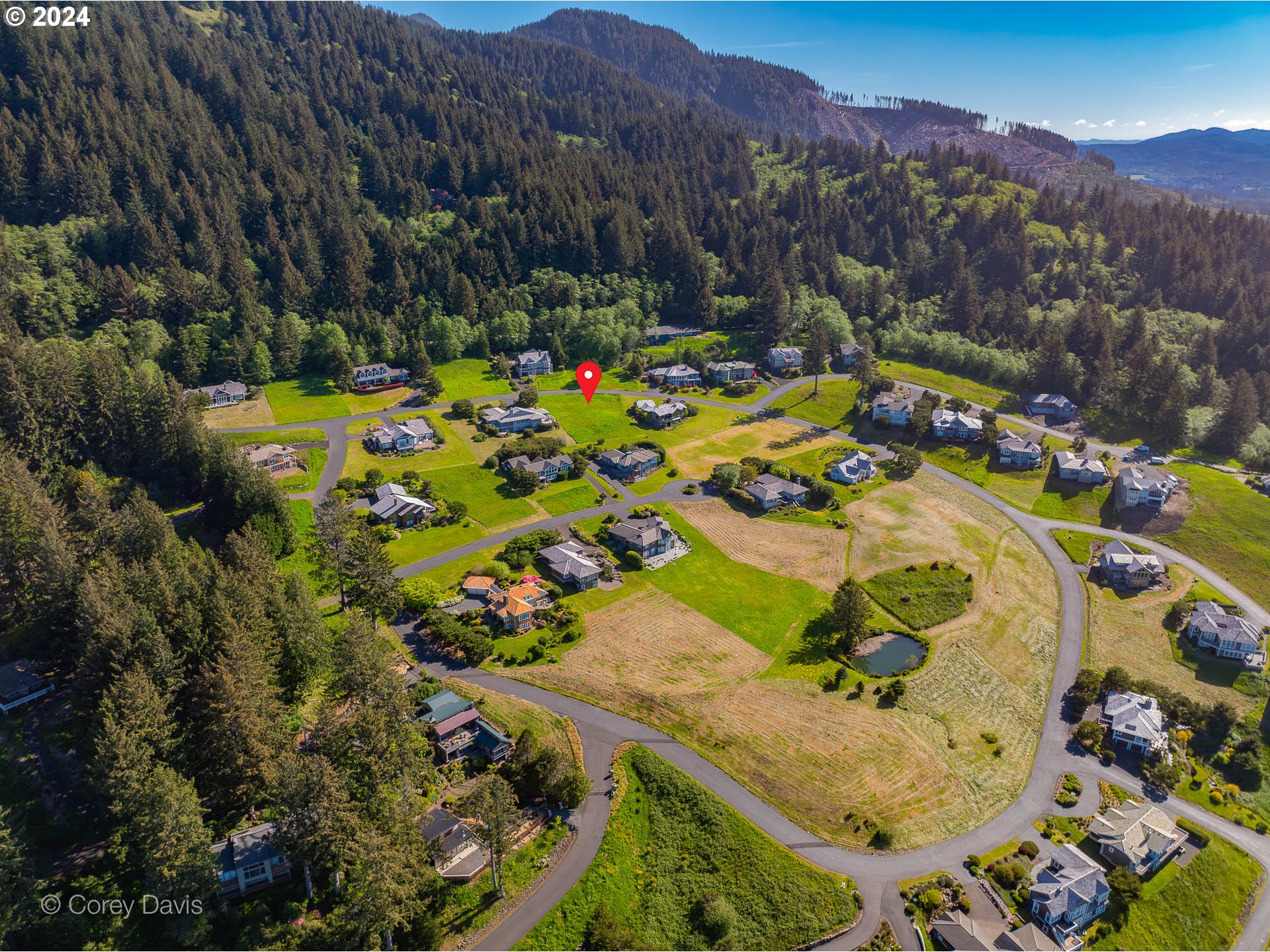 Meadow Loop, Unit 14 Nehalem, OR 97131 - Photo 16 of 22 a view of swimming pool with a yard and mountain view in back