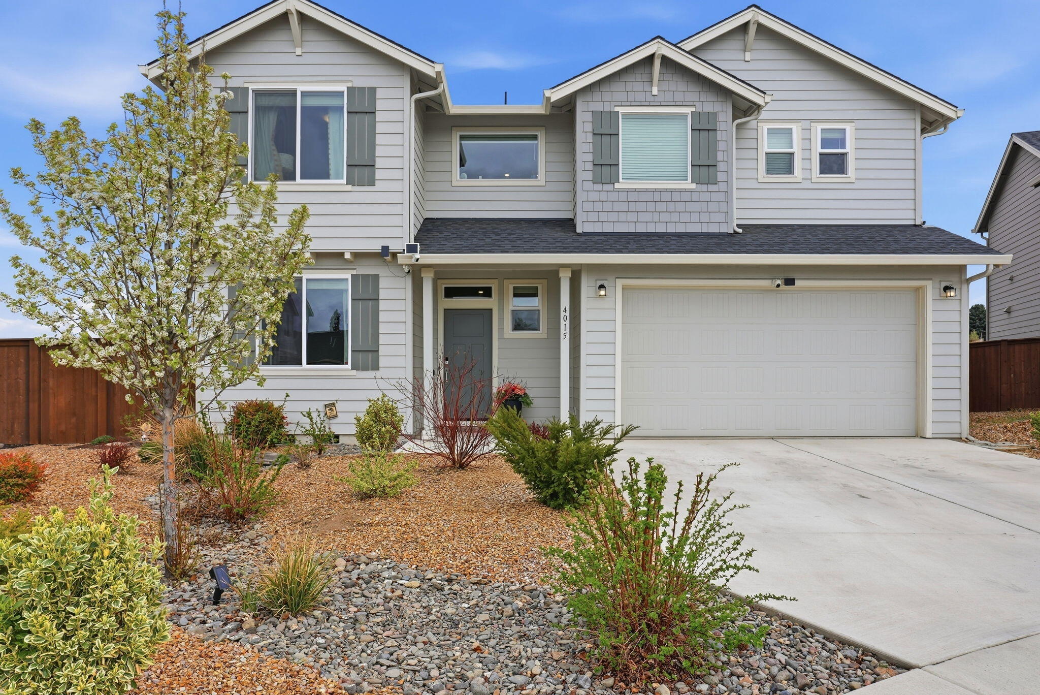 4015 Southwest Quartz Place Redmond, OR 97756 - Photo 1 of 35 a front view of a house with a yard and garage