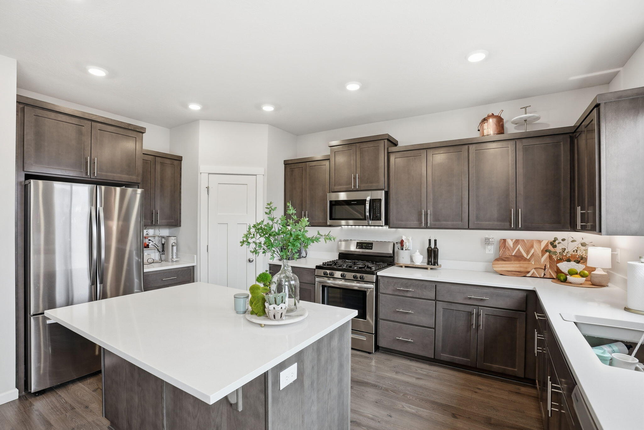 4015 Southwest Quartz Place Redmond, OR 97756 - Photo 11 of 35 a kitchen with a refrigerator a sink a stove a microwave and cabinets