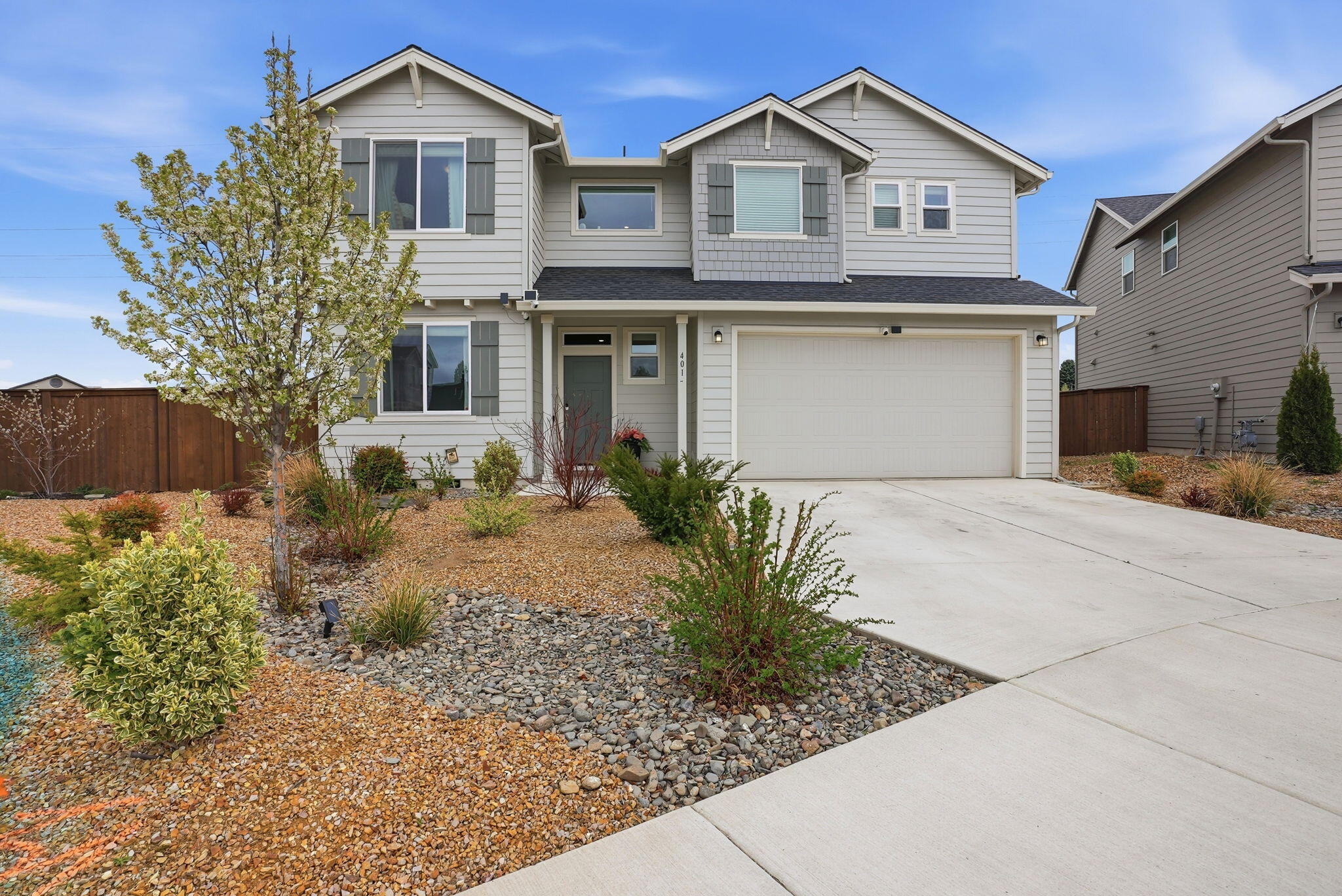 4015 Southwest Quartz Place Redmond, OR 97756 - Photo 2 of 35 a front view of a house with garden