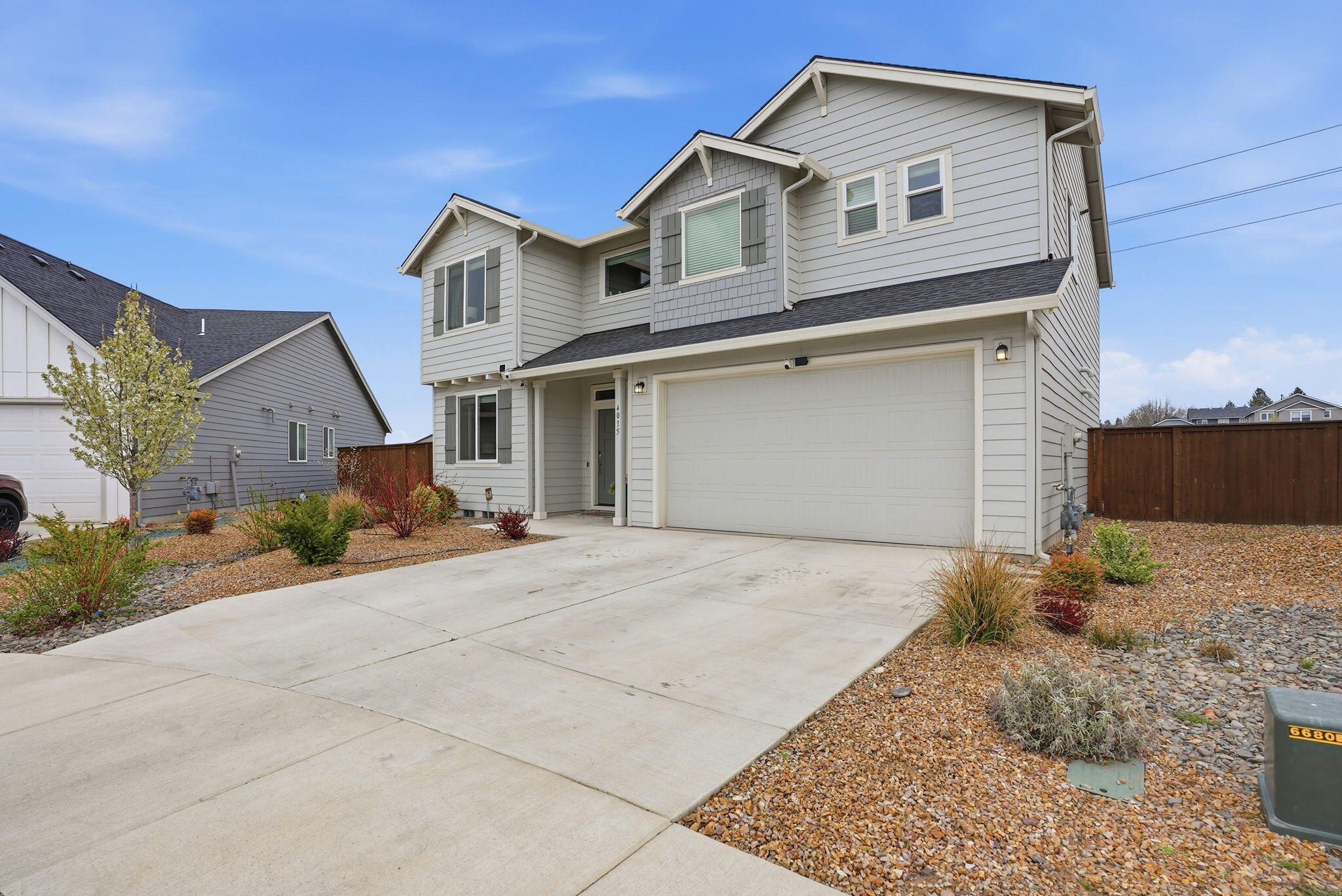 4015 Southwest Quartz Place Redmond, OR 97756 - Photo 3 of 35 a front view of a house with a yard and garage