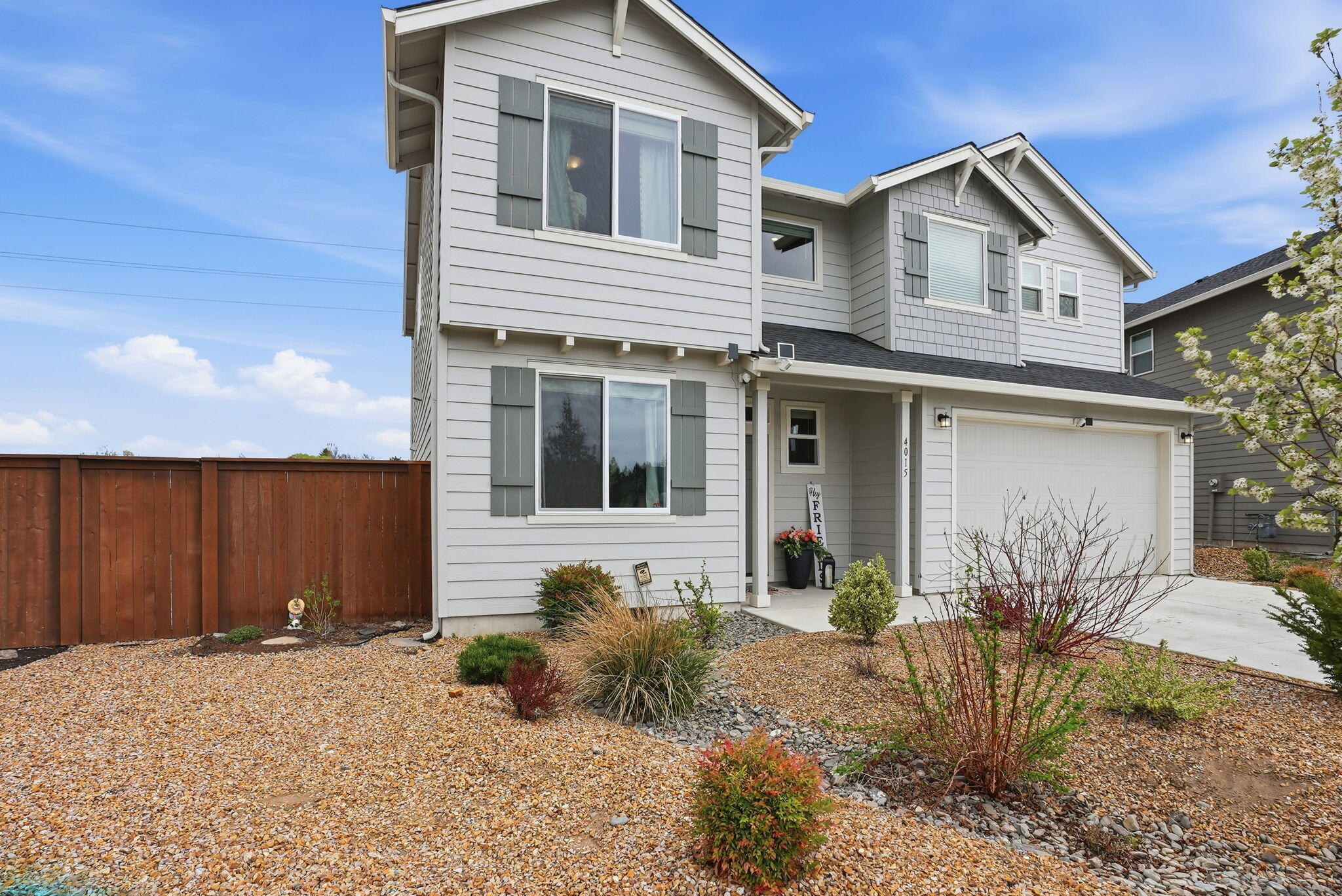 4015 Southwest Quartz Place Redmond, OR 97756 - Photo 4 of 35 a front view of a house with garden