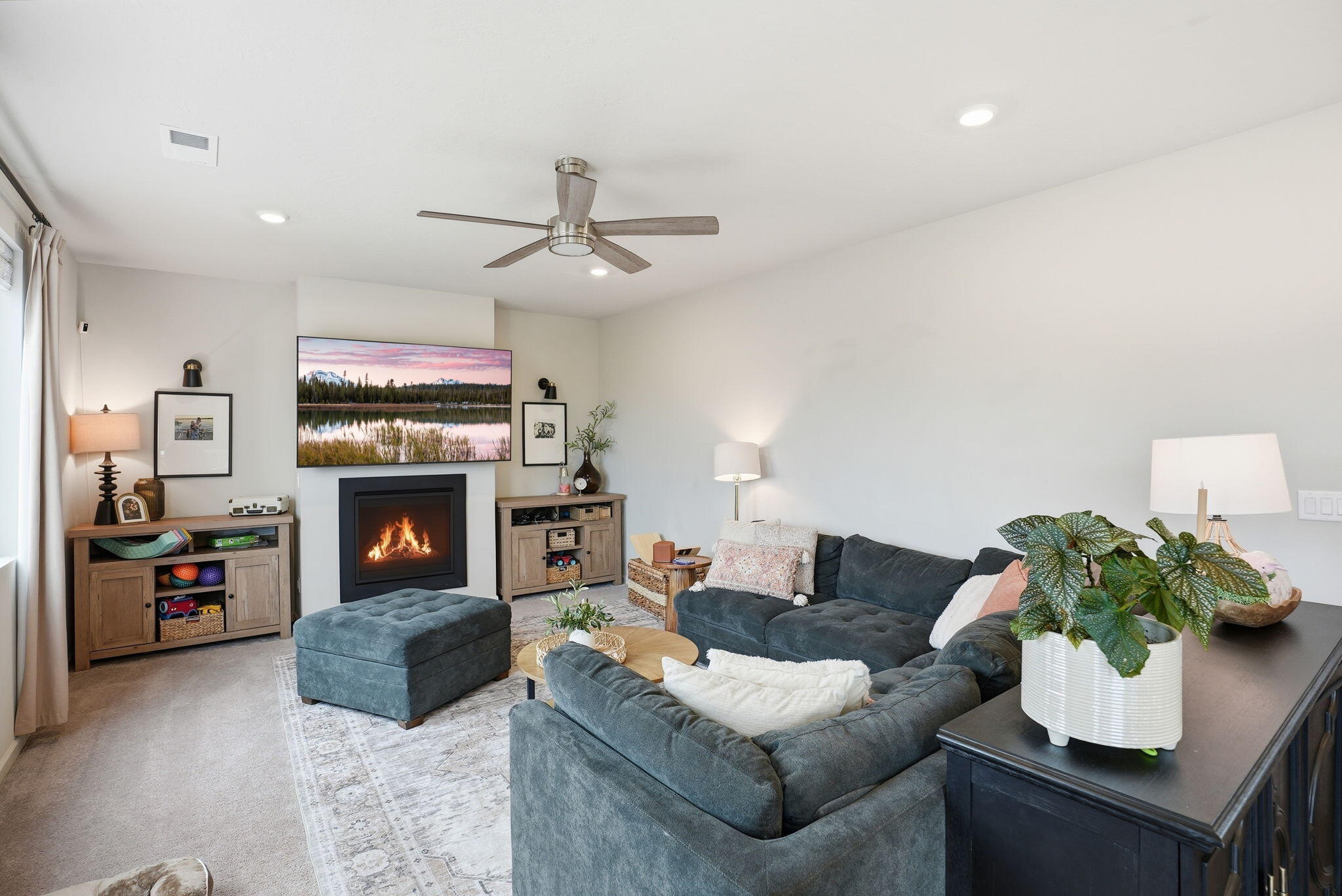 4015 Southwest Quartz Place Redmond, OR 97756 - Photo 6 of 35 a living room with furniture a fireplace and a flat screen tv