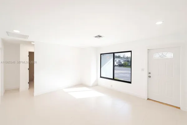 a view of an empty room with a window