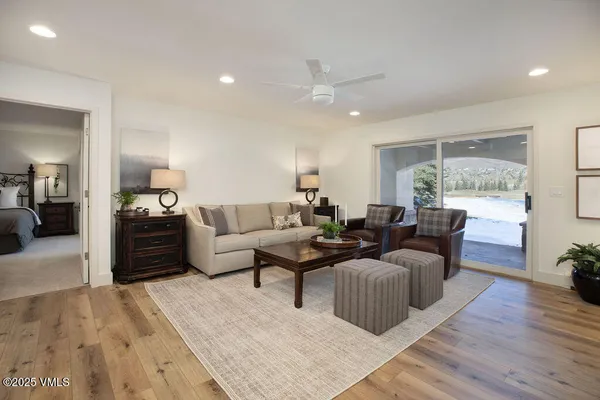 a living room with furniture and a wooden floor