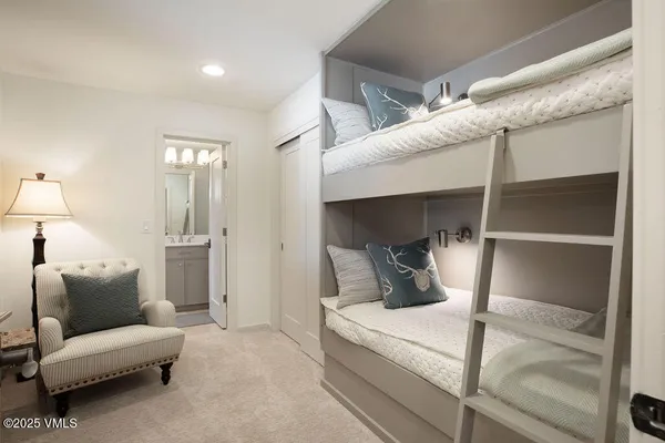 a bedroom with furniture and a lamp