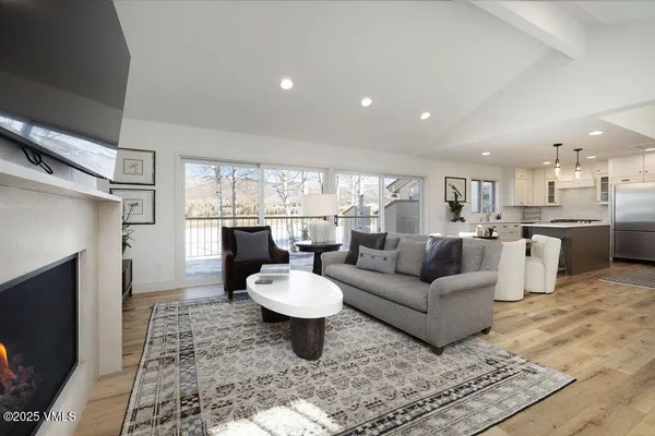 a living room with furniture a fireplace and a flat screen tv