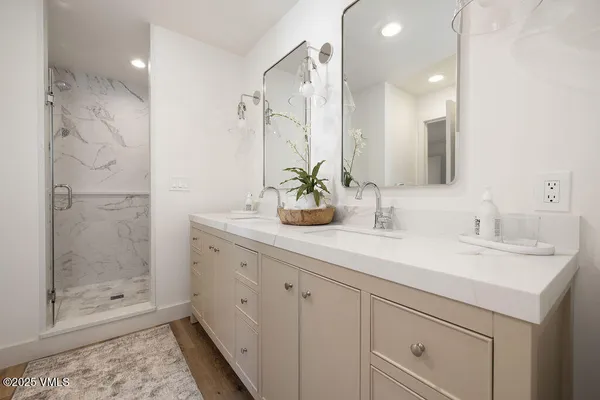 a bathroom with a shower sink and mirror