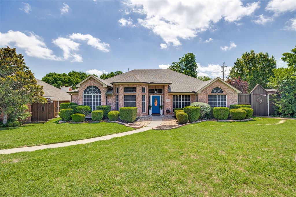 2100 Los Rios Boulevard Plano, TX 75074 - Photo 2 of 25 Brick exterior residence featuring a distinctive blue front door