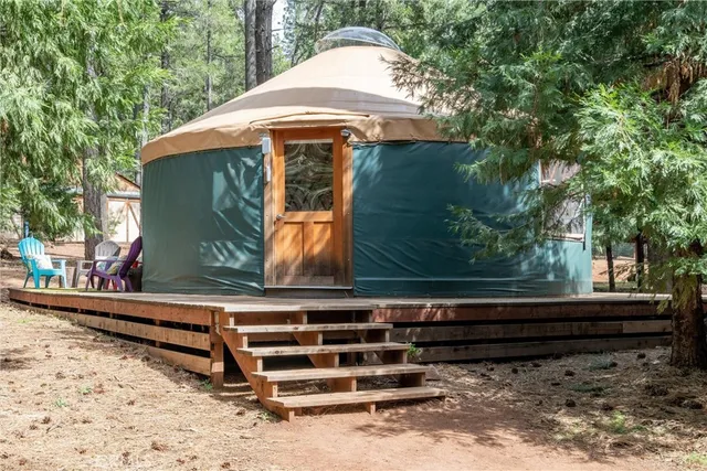 a view of a balcony with a floor to ceiling window and wooden fence