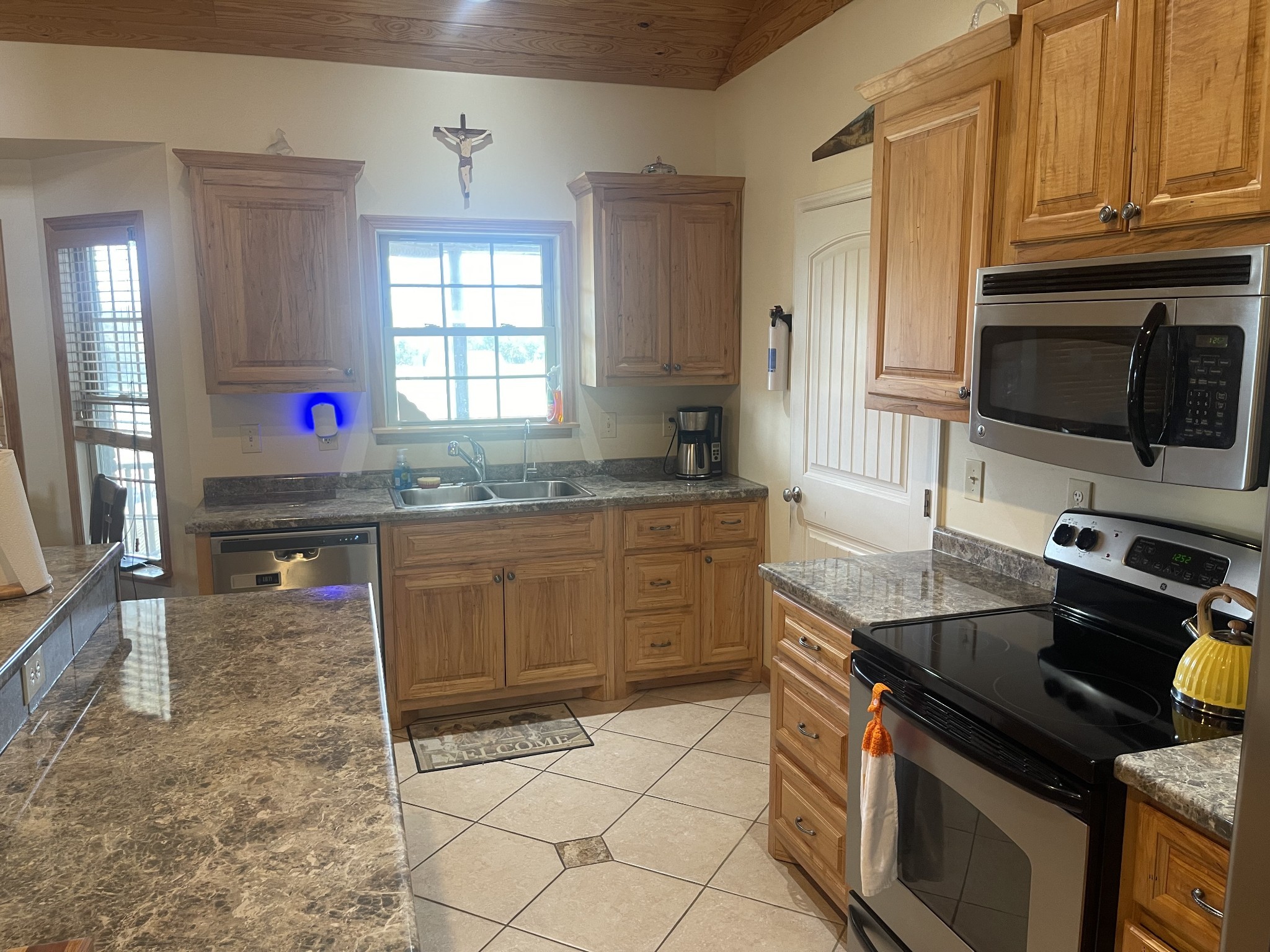 295 White Road Pulaski, TN 38478 - Photo 27 of 49 a kitchen with a stove a sink and a microwave