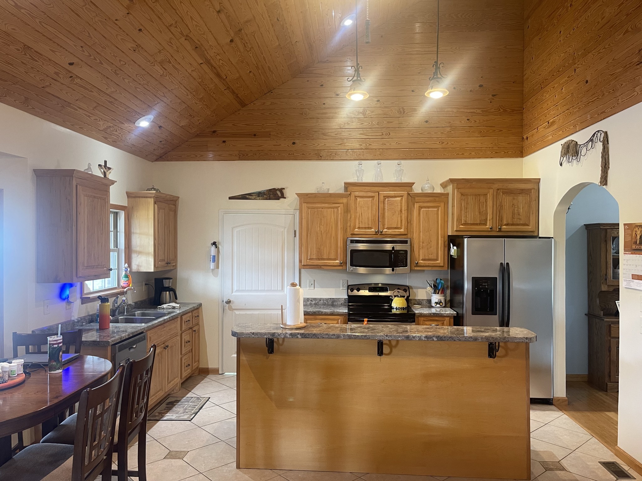 295 White Road Pulaski, TN 38478 - Photo 28 of 49 a kitchen with stainless steel appliances a sink a stove a refrigerator cabinets and a dining table