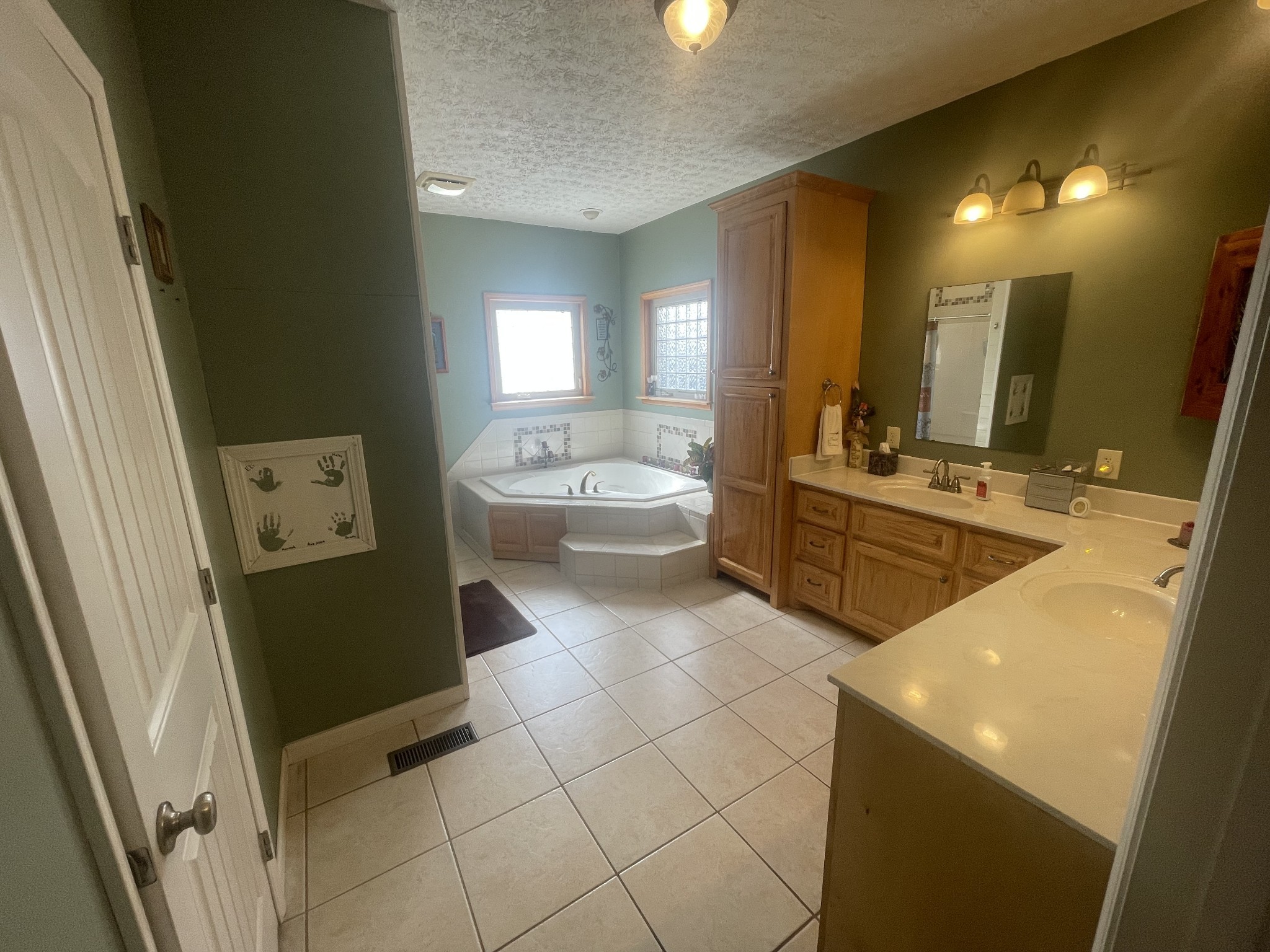 295 White Road Pulaski, TN 38478 - Photo 39 of 49 a spacious bathroom with a double vanity sink a mirror and a bathtub