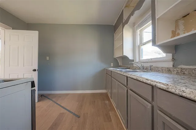 a bathroom with a granite countertop sink and a vanity