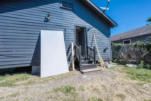 a view of a wooden house with a small yard