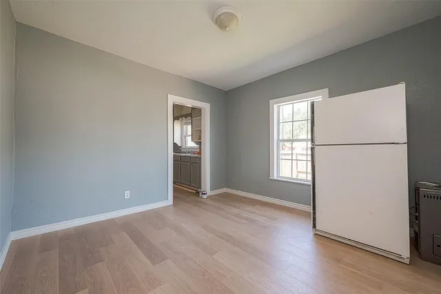 an empty room with closet and windows