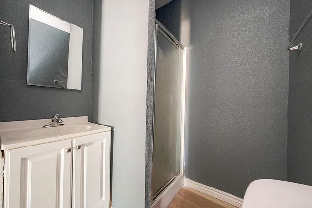 a bathroom with a sink a toilet and mirror