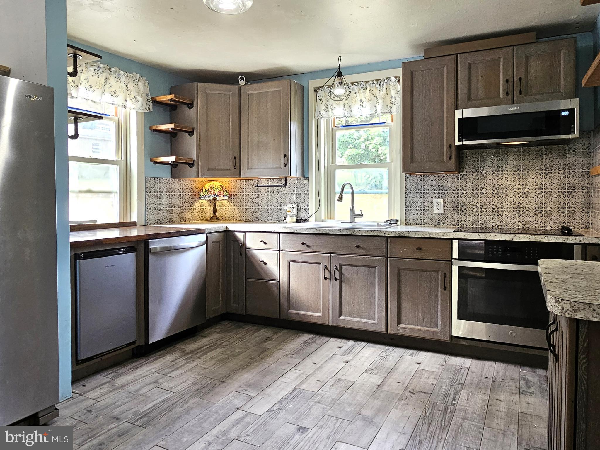 683 North Manor Road Elverson, PA 19520 - Photo 2 of 14 a kitchen with stainless steel appliances a sink cabinets and a window