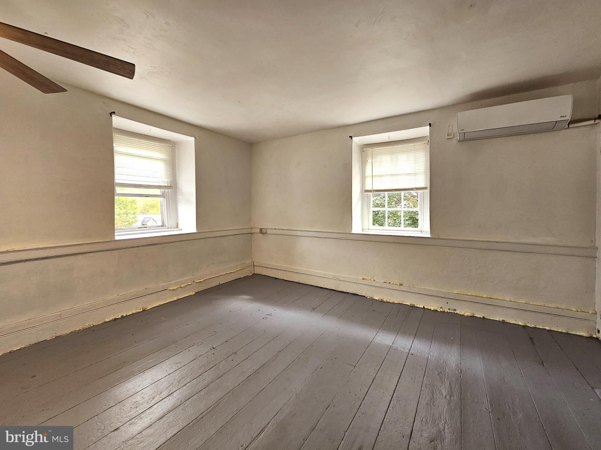 683 North Manor Road Elverson, PA 19520 - Photo 8 of 14 an empty room with wooden floor and windows