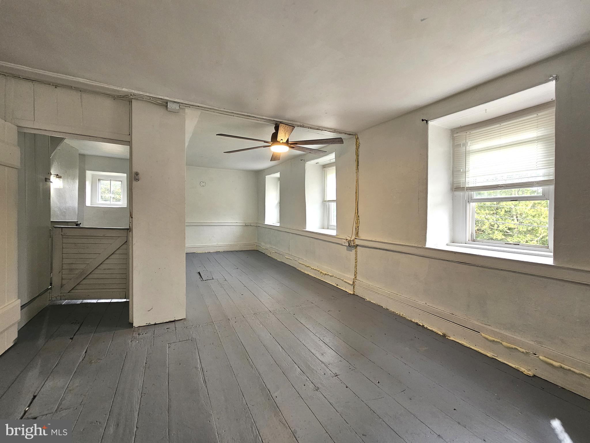 683 North Manor Road Elverson, PA 19520 - Photo 9 of 14 an empty room with wooden floor and windows