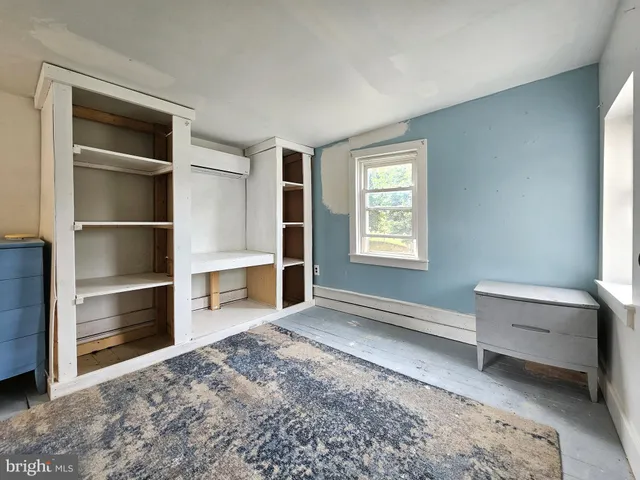 a view of workspace with furniture and window in a room