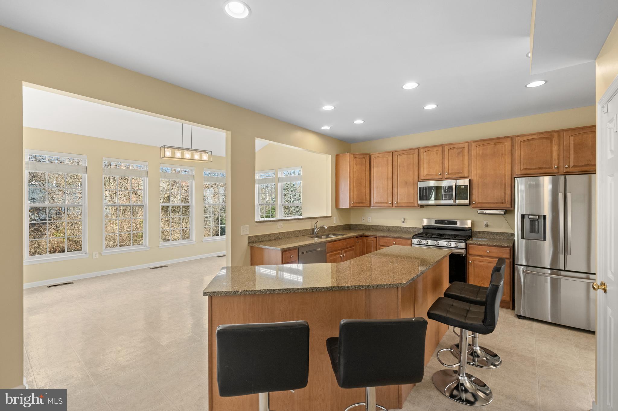 6 Huntingdon Court Marcus Hook, PA 19061 - Photo 10 of 35 a kitchen with stainless steel appliances granite countertop a refrigerator a stove top oven a sink dishwasher and white cabinets with wooden floor