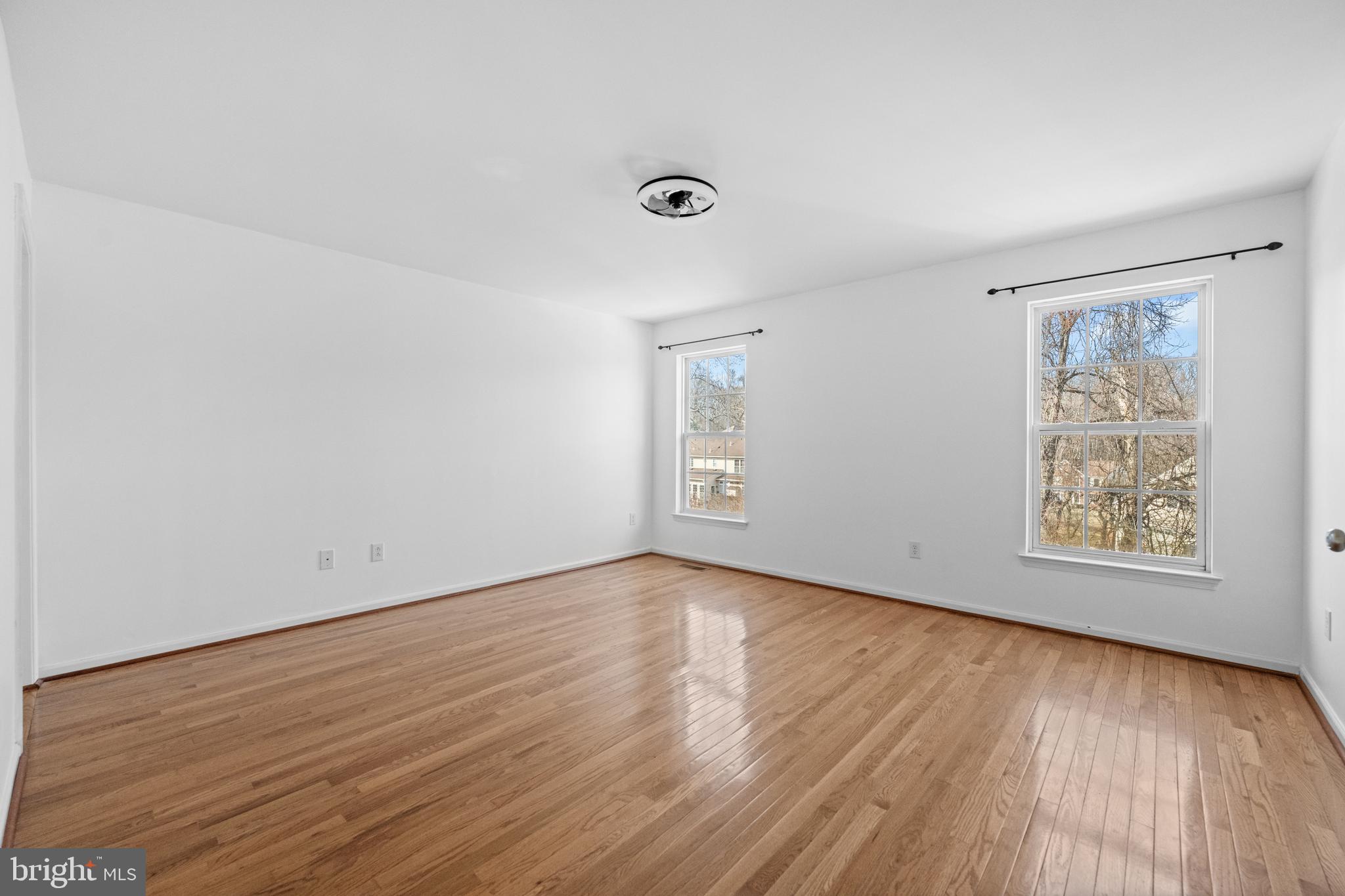 6 Huntingdon Court Marcus Hook, PA 19061 - Photo 15 of 35 a view of an empty room with wooden floor and a window
