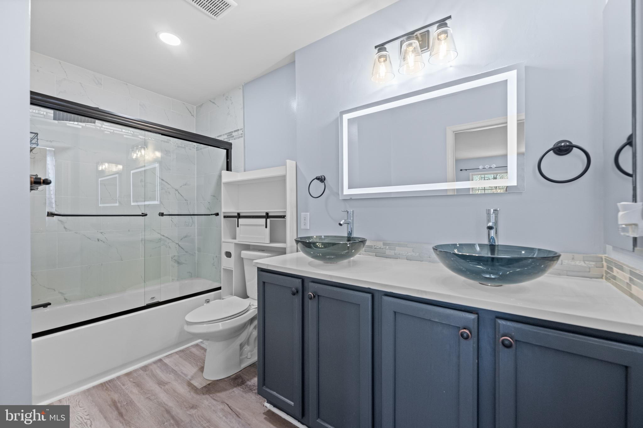 6 Huntingdon Court Marcus Hook, PA 19061 - Photo 16 of 35 a bathroom with a granite countertop sink a toilet and mirror