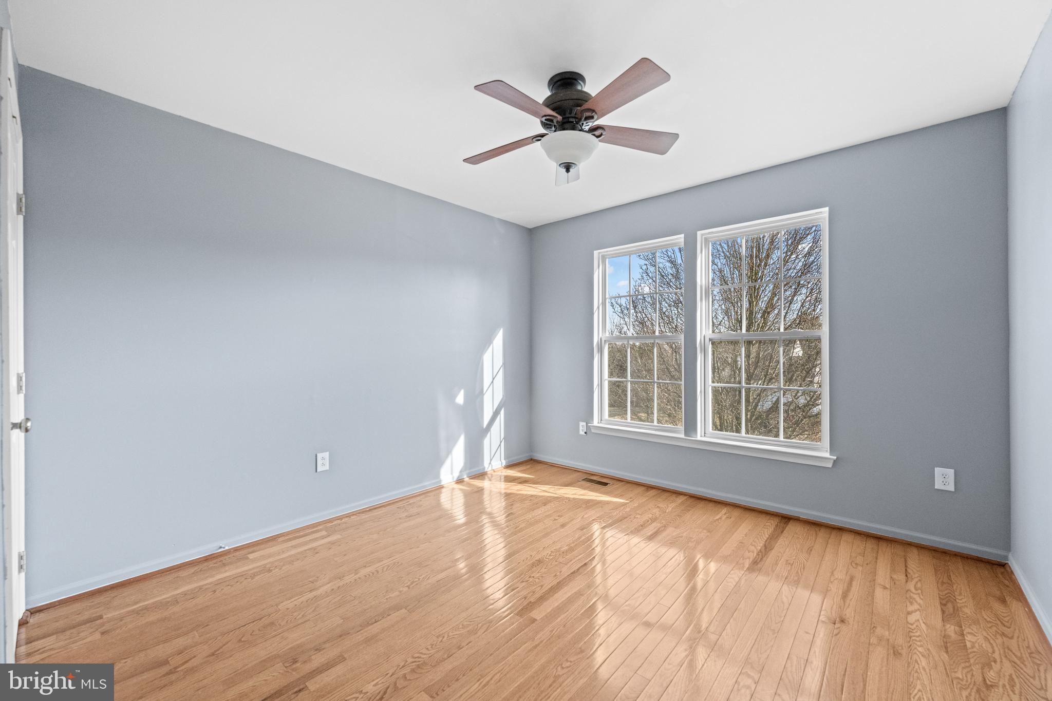 6 Huntingdon Court Marcus Hook, PA 19061 - Photo 21 of 35 a view of an empty room with wooden floor and a window