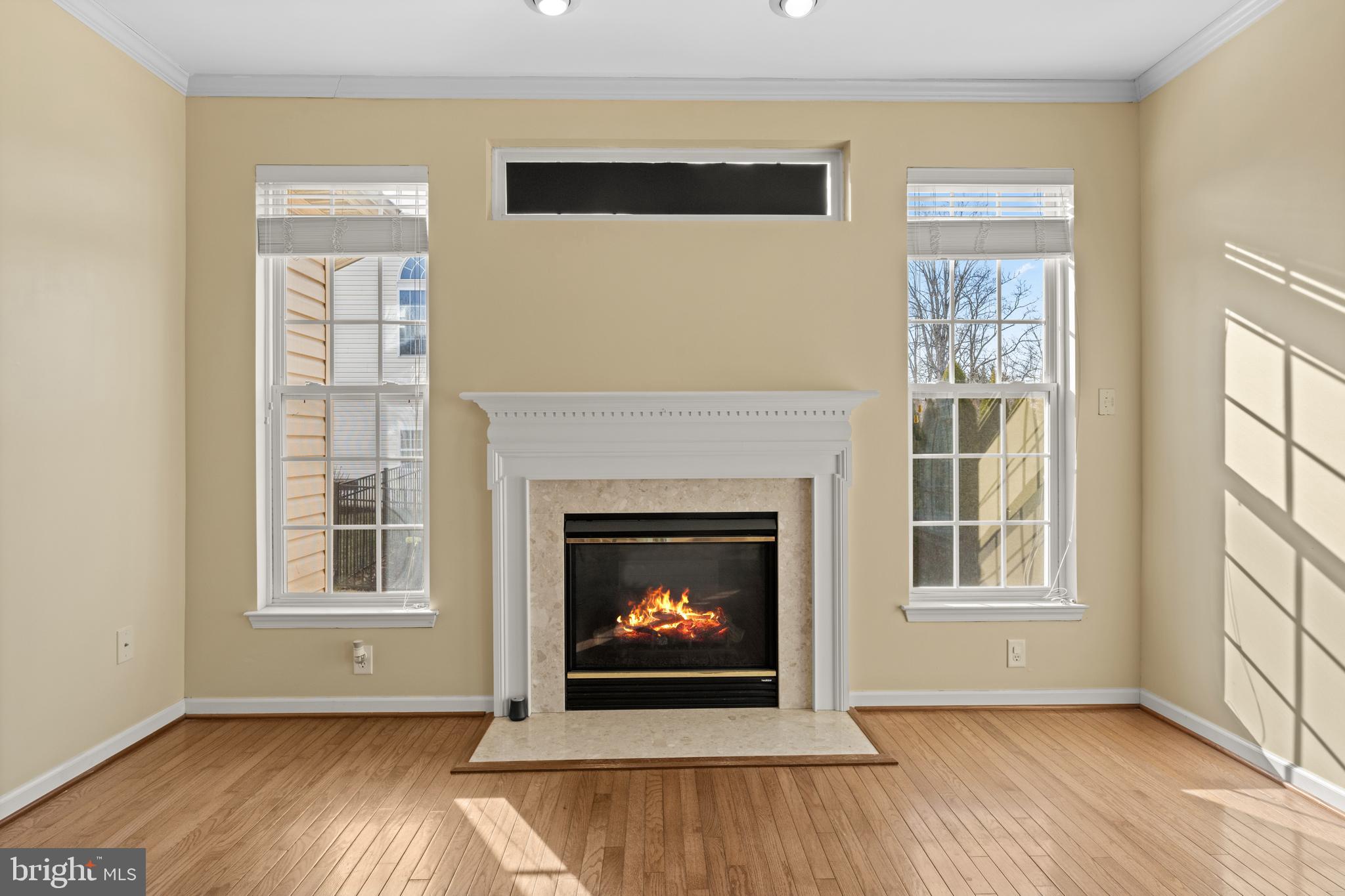 6 Huntingdon Court Marcus Hook, PA 19061 - Photo 7 of 35 a view of an empty room with wooden floor fireplace and a window