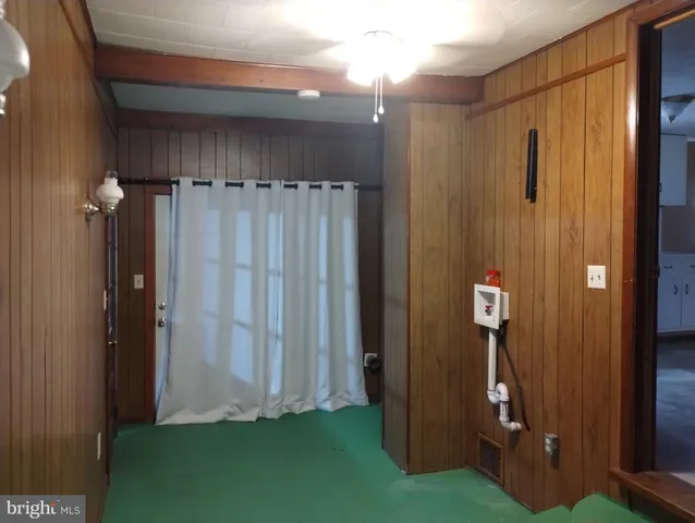 a view of a bathroom with a shower and a mirror